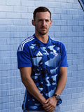 Front view of man wearing navy camo adidas Team Scotland jersey.