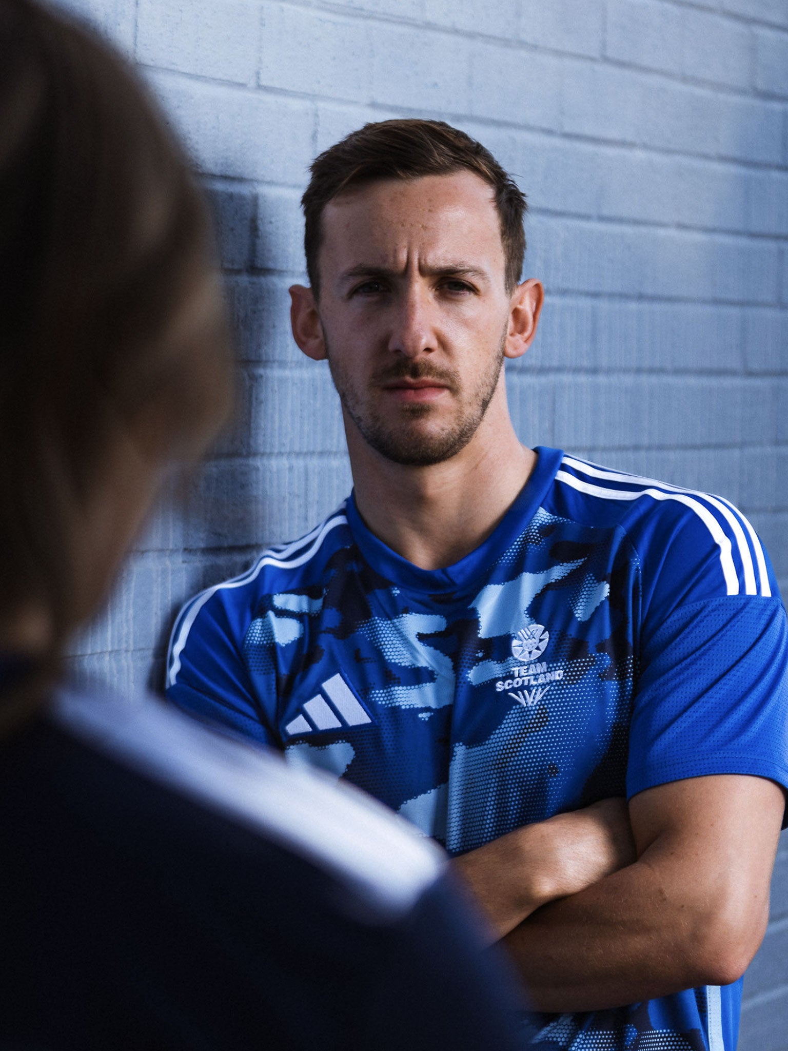 Front view of man wearing navy camo adidas Team Scotland jersey.