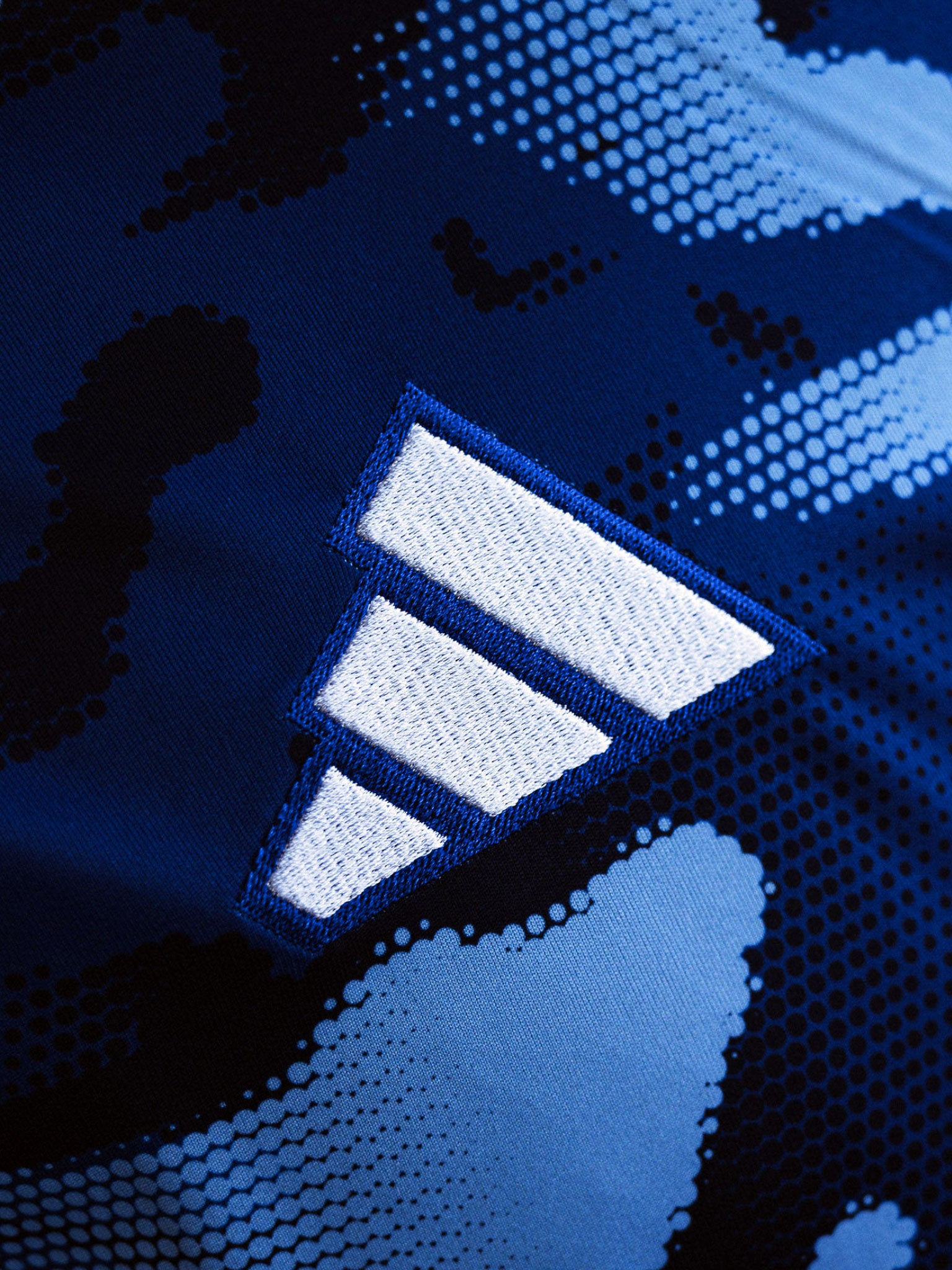 close up view of navy camo adidas Team Scotland jersey showing adidas logo embroidery.