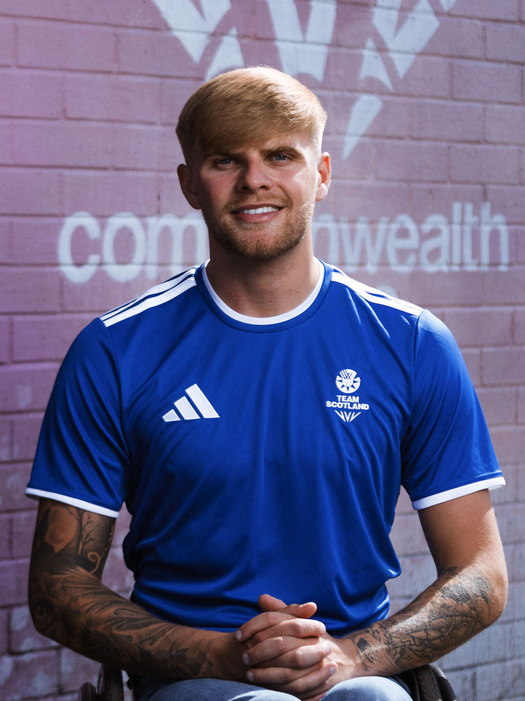 Front view of man wearing royal blue adidas Team Scotland jersey.