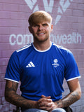 Front view of man wearing royal blue adidas Team Scotland jersey.