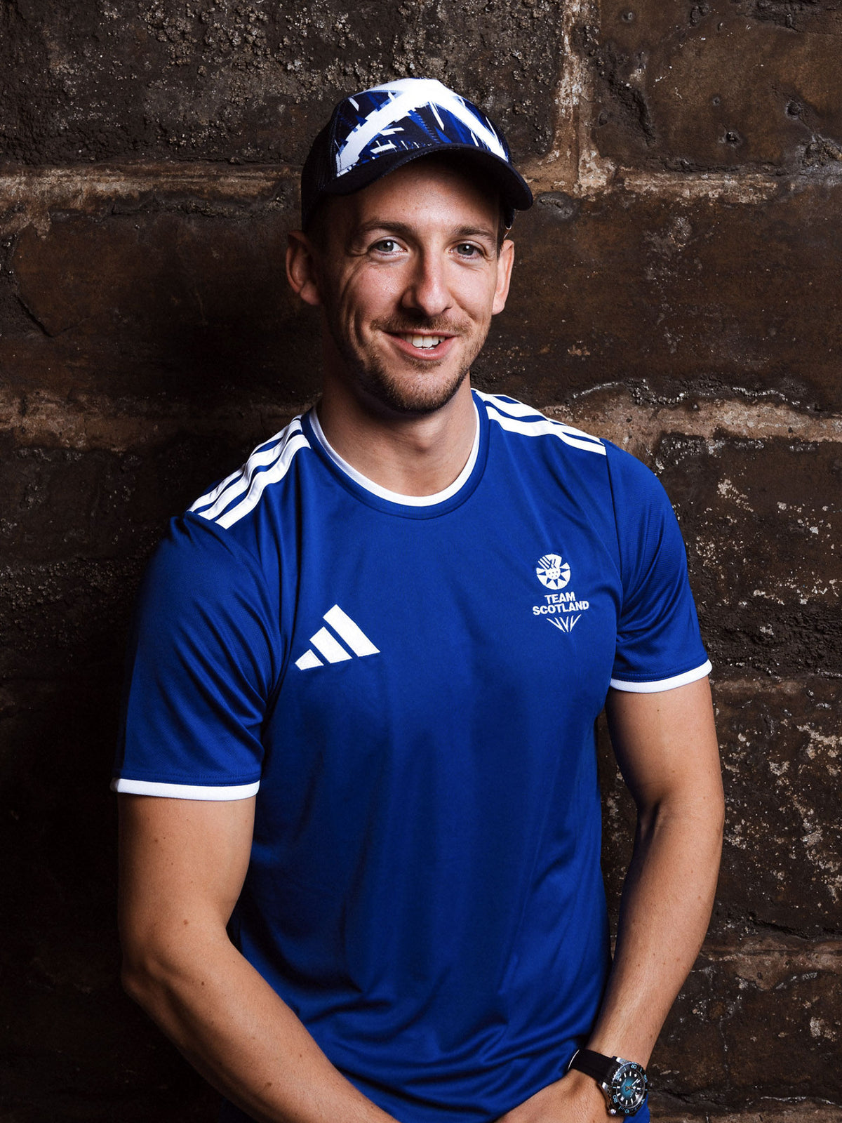 Front view of man wearing royal blue adidas Team Scotland jersey.