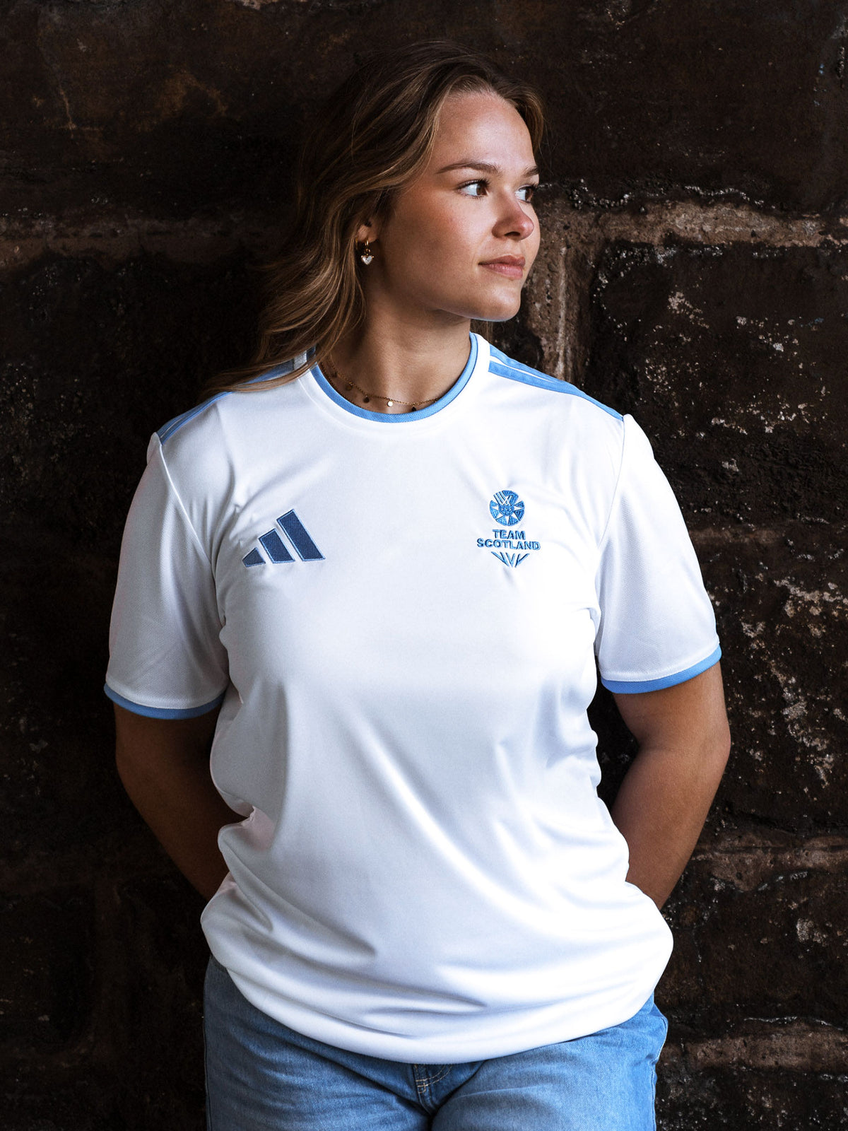 Front view of woman wearing white adidas Team Scotland jersey.