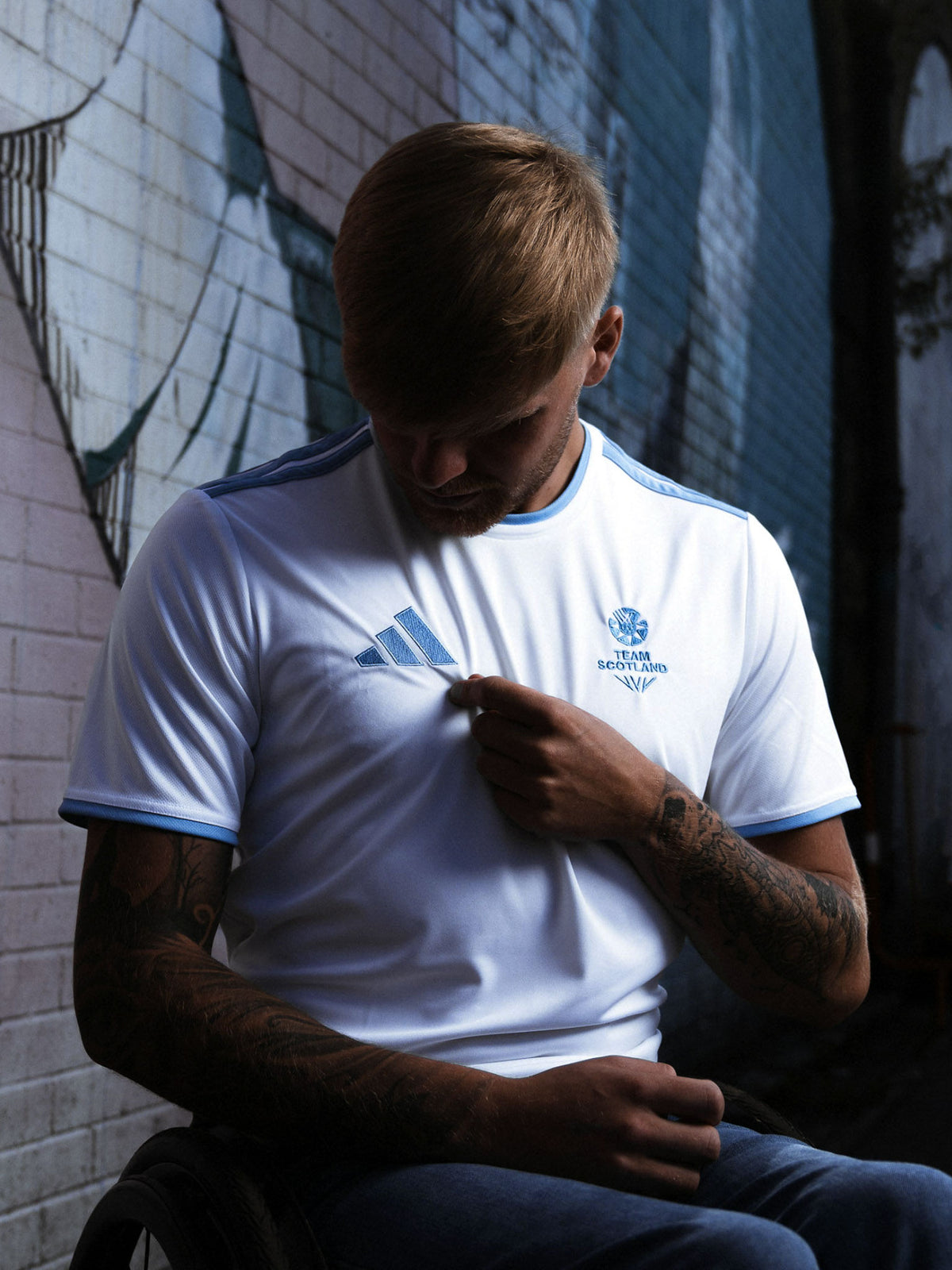 Front view of man wearing white adidas Team Scotland jersey.
