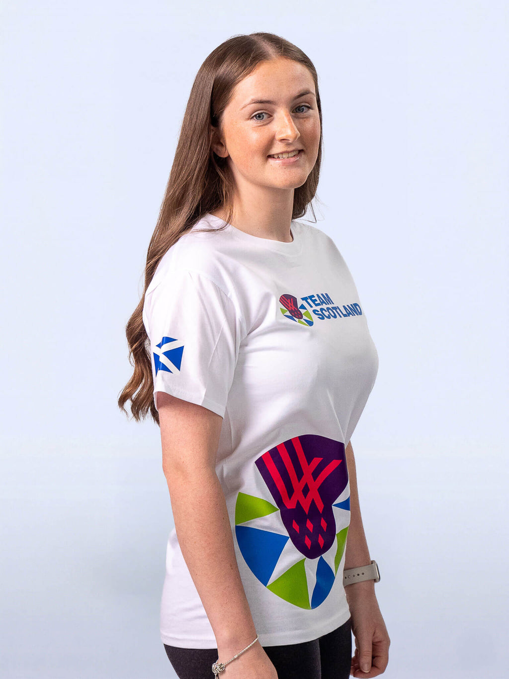 3/4 view of white t-shirt with Team Scotland logo and logomark sideprint worn by athlete Beth Riva
